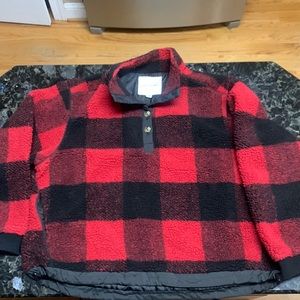 Women’s red/black fleece sweater with draw string bottom.